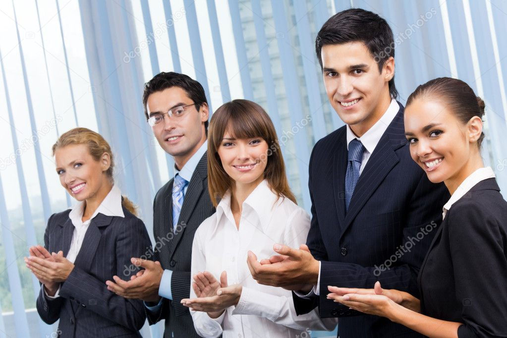 Happy businesspeople applauding at office