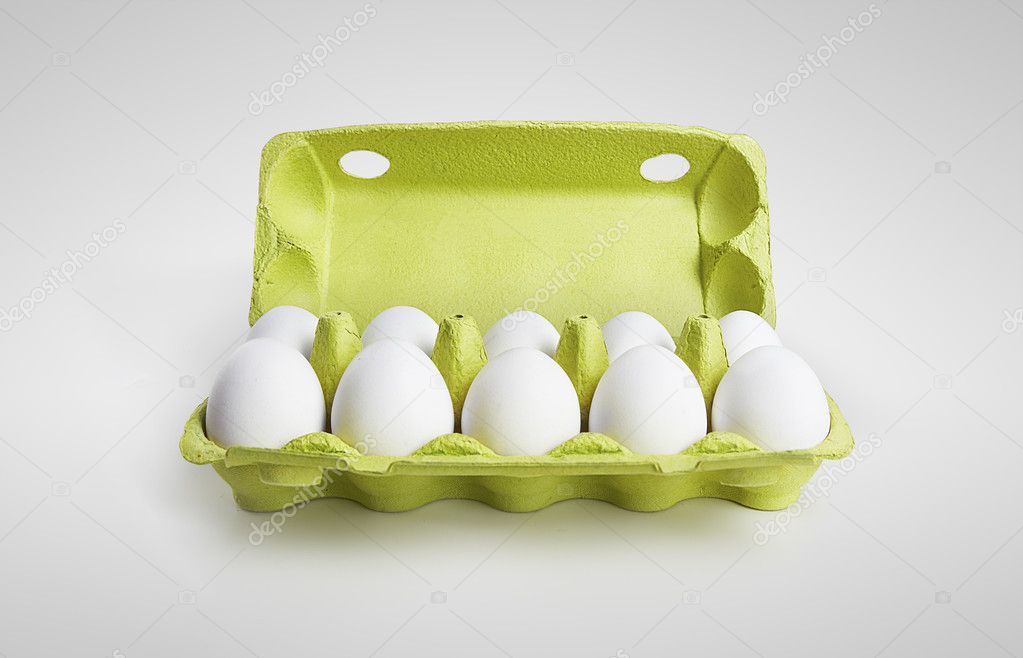 Ten white eggs in a carton box
