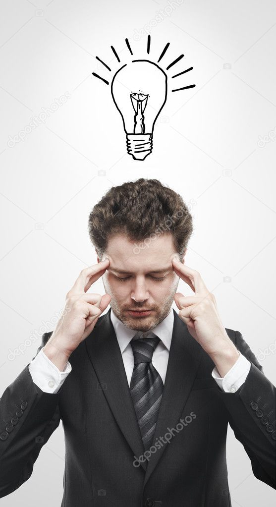 Portrait of a young man with light bulb above his head.