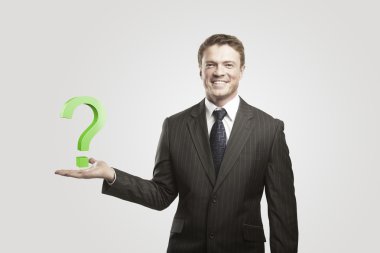 Young businessman with a question mark on his hand. clipart