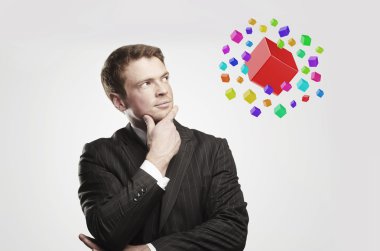 Young businessman with colored boxes. clipart