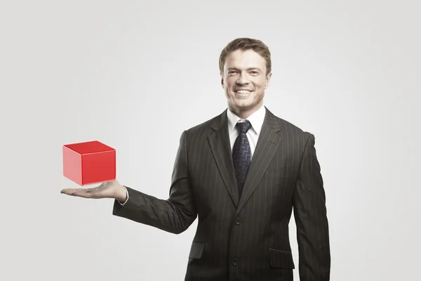 Young businessman with red box. — Stock Photo, Image