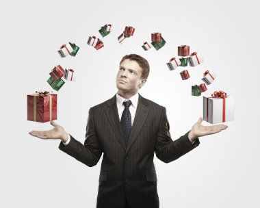 Young businessman with a gift boxes in his hands. clipart