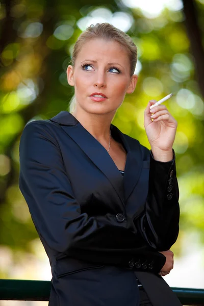 stock image Young business woman smoking cigarette