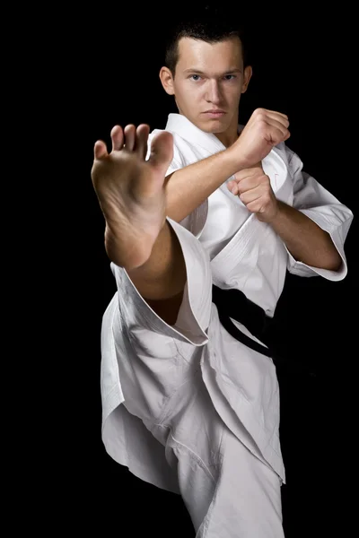 Young fighter on black — Stock Photo, Image