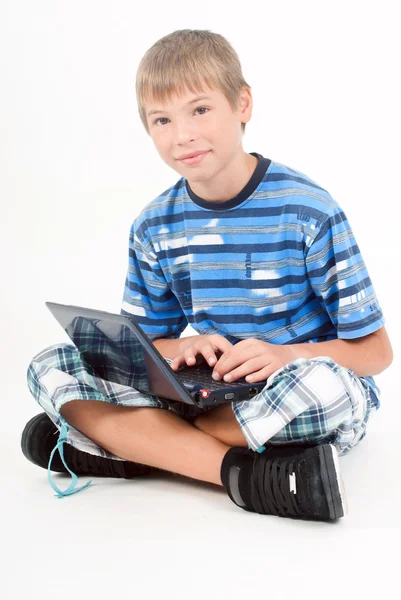笔记本电脑，白色上孤立的年轻孩子 图库照片