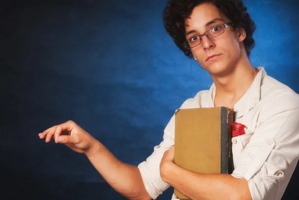 Teenager holding book in his hand — Stock Photo, Image