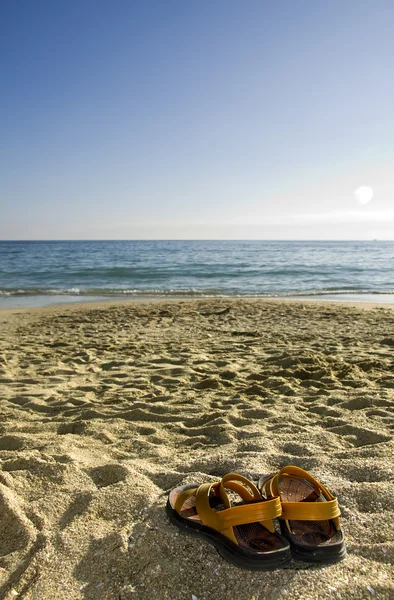 Zomer sandalen in het zand op het strand — Stockfoto