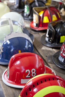 Several fireman helmets in row