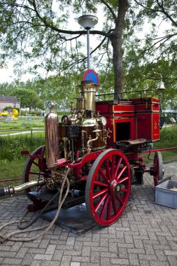 Very old red fire engine on street