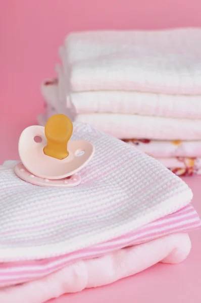 Pink Pacifier and Baby Clothes — Stock Photo, Image