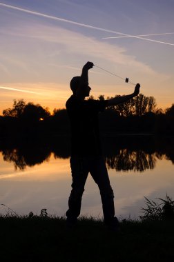 Yo-Yo player by the lake clipart