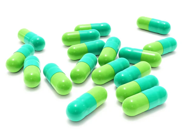 Molte pillole bicolore su bianco — Foto Stock