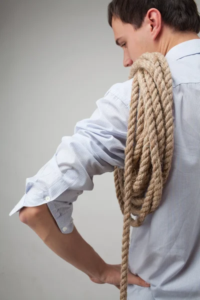 Young man with a rope on his shoulder — Stock Photo, Image