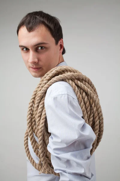 Young man with a rope on his shoulder — Stock Photo, Image