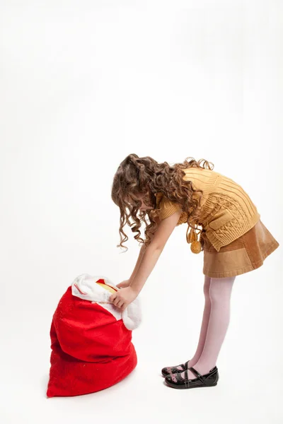 Girl and a bag of gifts — Stock Photo, Image