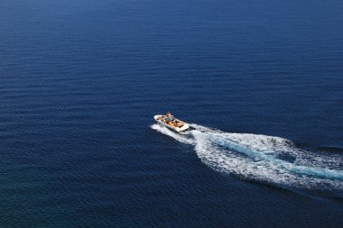 Speed boat aerial view on blue sea clipart