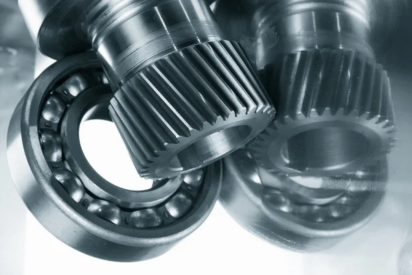 Ball bearings, gears against brushed aluminum — Stock Photo, Image