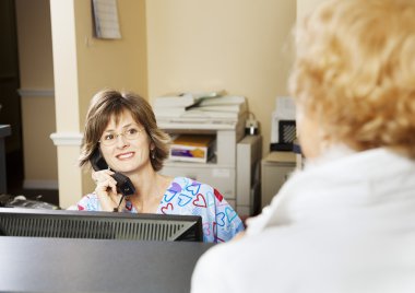 Receptionist Greets Patient clipart