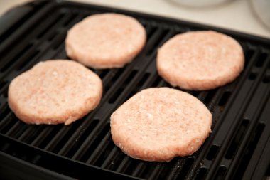 Raw Turkey Burgers on Grill clipart