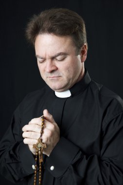 Priest Says the Rosary clipart