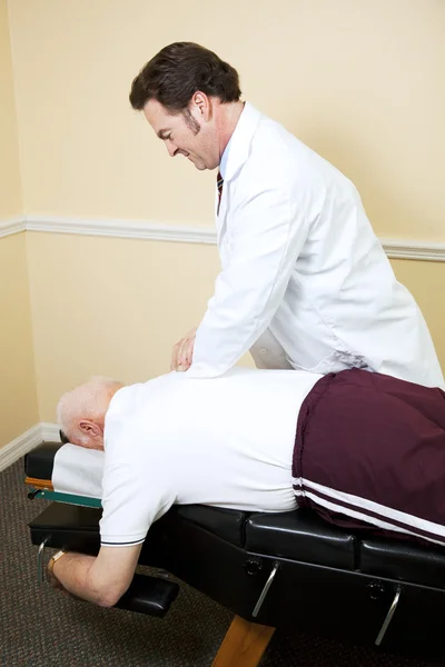 Chiropractor Adjusts Senior Man — Stock Photo, Image