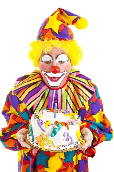 Un clown souffle une bougie d'anniversaire — Photo