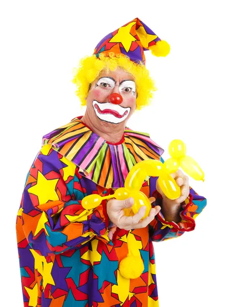 Отвратительный клоун с воздушным псом — стоковое фото