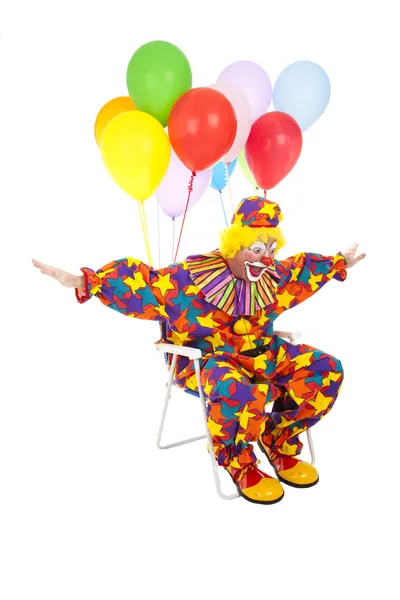 Flygande clown i gräsmatta stol — Stockfoto