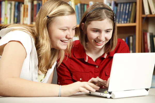 Adolescente niñas uso computadora en biblioteca —  Fotos de Stock