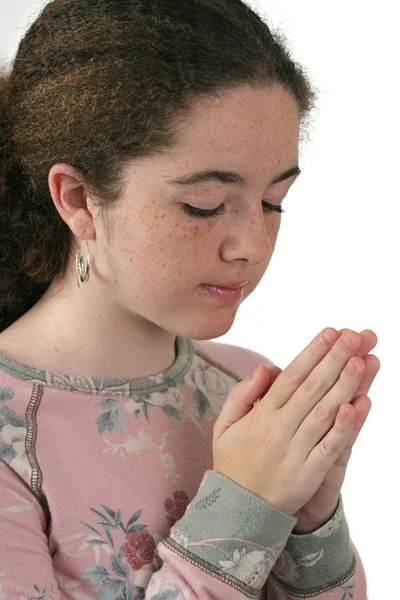 Uma menina adolescente atraente orando — Fotografia de Stock