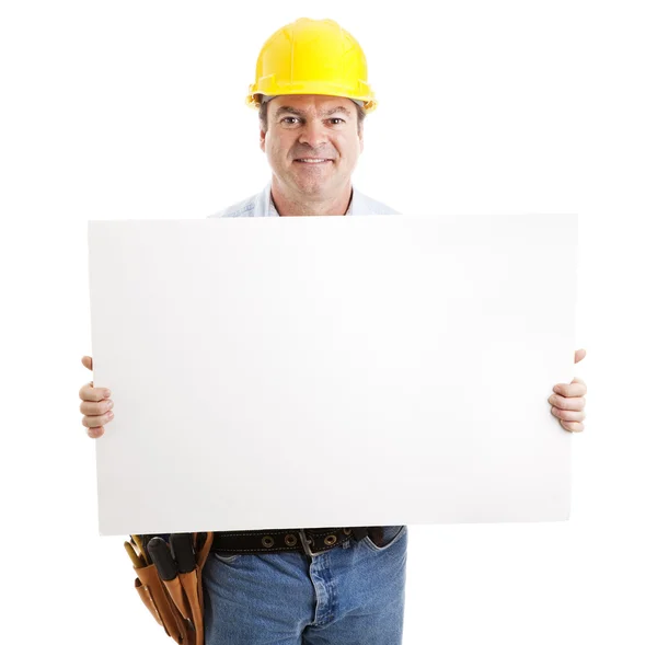 Freundlicher Bauarbeiter mit Schild — Stockfoto