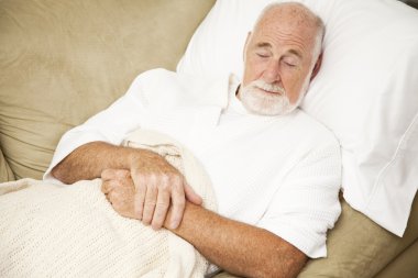 Senior Man Sleeps on Couch clipart