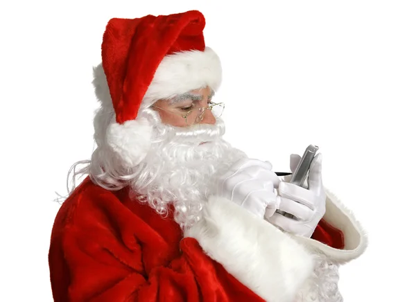 Santa kontrollerar listan på pda — Stockfoto