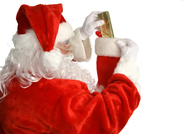 Weihnachtsmann stopft Strumpf — Stockfoto