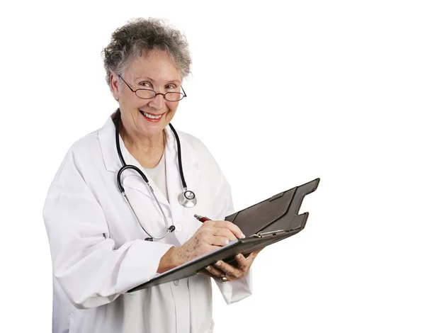 Amigável médico feminino toma notas — Fotografia de Stock