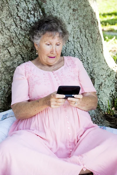 Starší žena, zmatený SMS — Stock fotografie