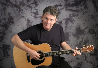 Stock Photo of a Mature Male Guitarist 1 clipart