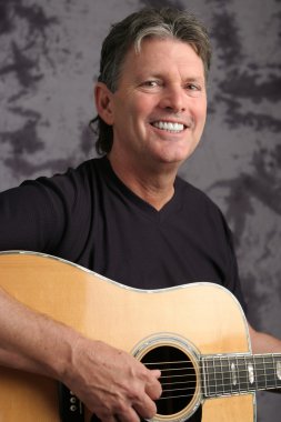 Stock Photo of Mature Male Guitarist 4 clipart