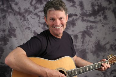 Stock Photo of a Mature Male Guitarist 6 clipart