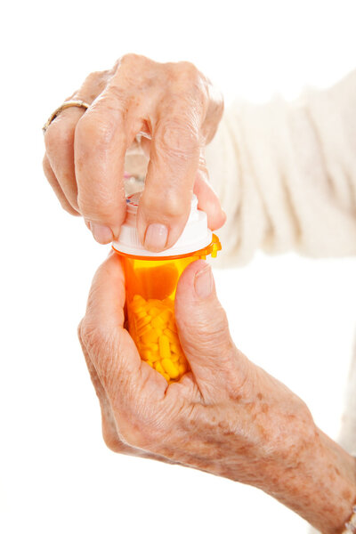 Senior Hands on Prescription Bottle