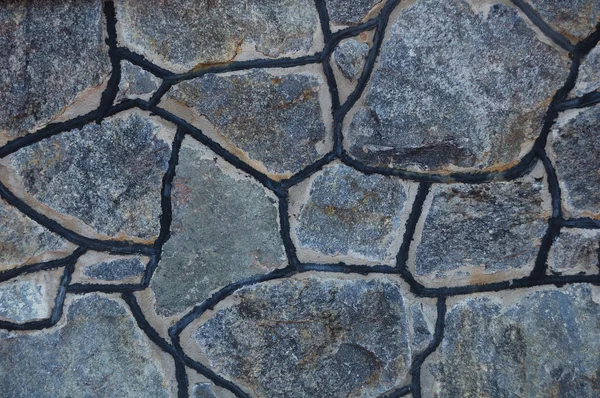 Un fragmento de la pared de piedras de granito colocadas en el fondo . —  Fotos de Stock