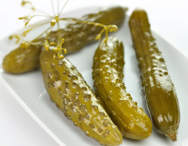 Dill pickles on a white dish — Stock Photo, Image