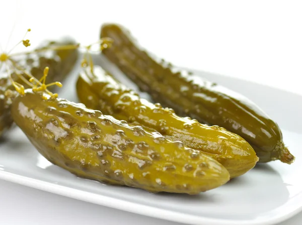 Dill pickles on a white dish — Stock Photo, Image