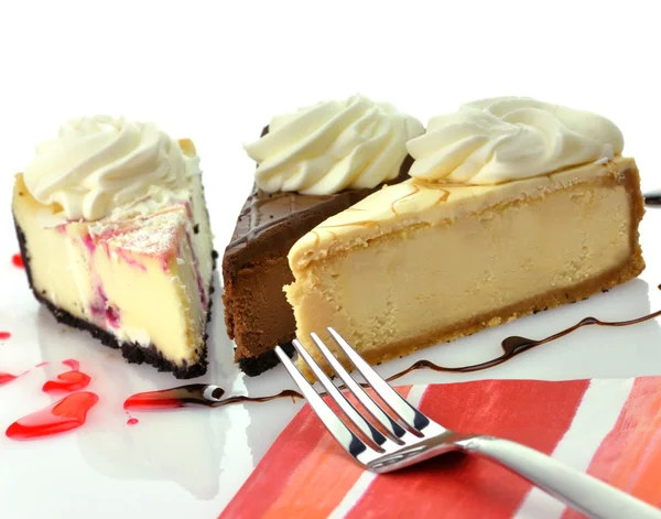 Slices of cheesecakes with fork and napkin — Stock Photo, Image