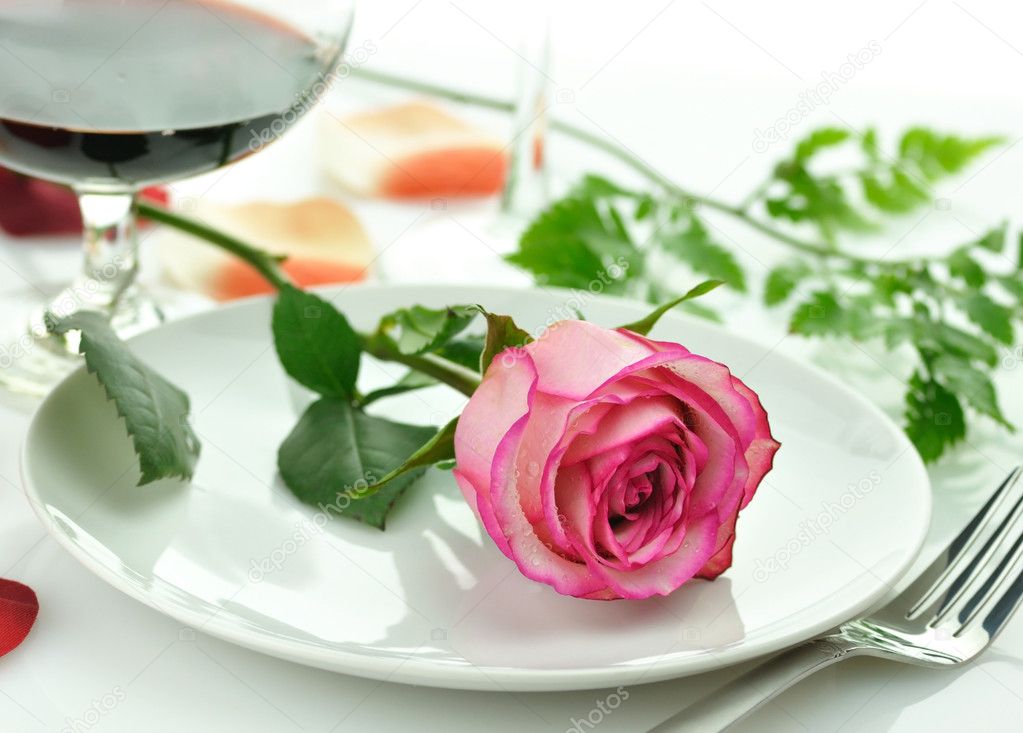 Romantic dinner with rose on a plate
