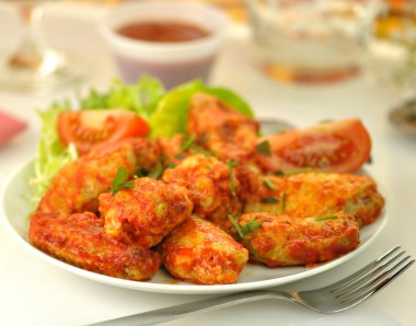 Hot chicken wings with salad clipart