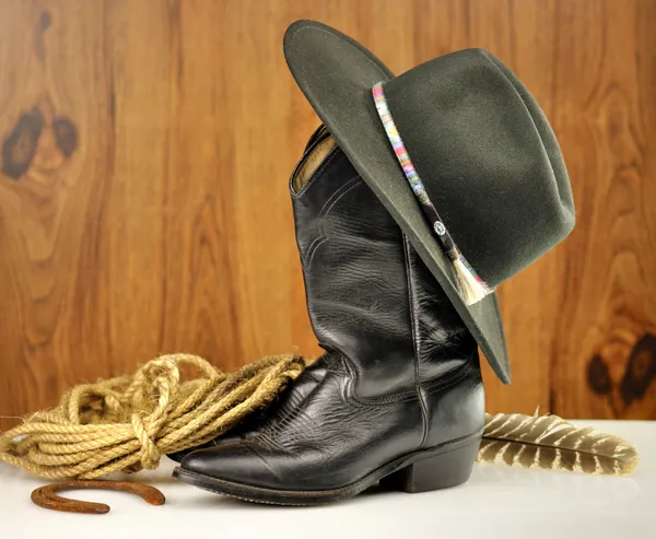 Zwarte cowboy hoed en laarzen Stockafbeelding