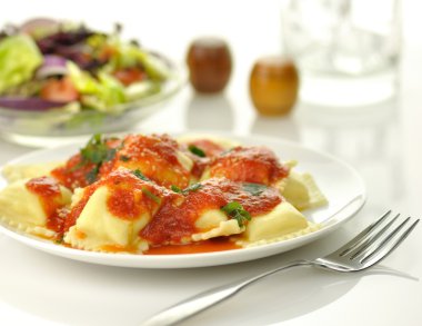 Ravioli pasta with red tomato sauce clipart