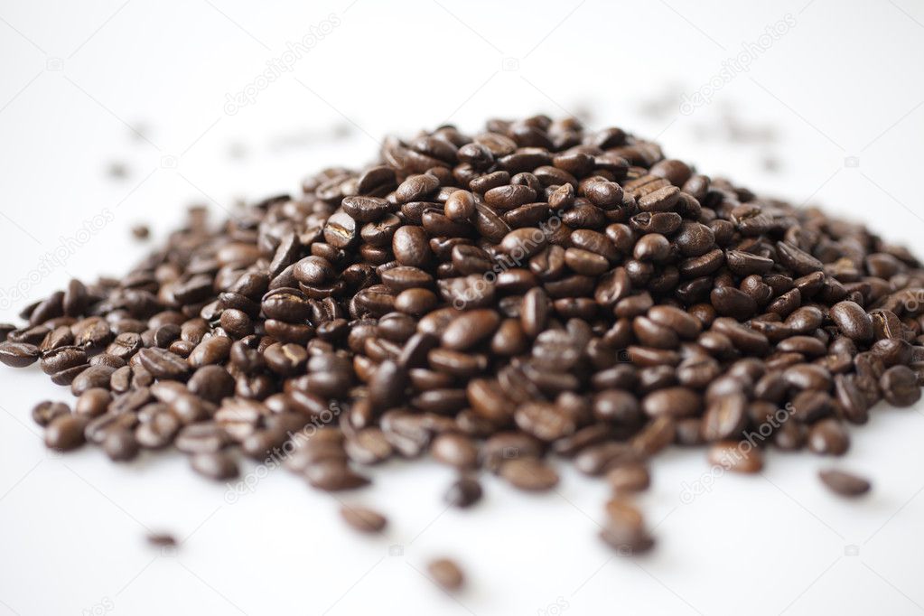 A heap of coffee beans on white background